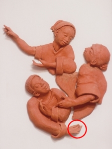 Close-up of Story Wall figures showing location of repair