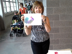 Liz with painting done at Iowa State Fair demonstration