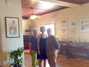 Jo Myers-Walker, Leslie Leavenworth, and Jan Vander Linden after hanging their artwork at Salt Fork Kitchen in Solon, Iowa