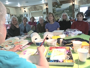 Class watching Jo Myers-Walker demonstrate painting technique at Summerset Winery