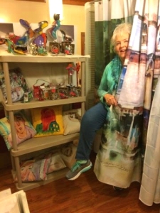 Artist Jo Myers-Walker with shower curtain digitally printed with her watercolor art
