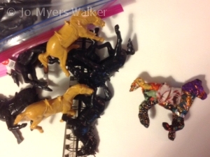 Plastic toy horses with one fabric-wrapped horse figure by Jo Myers-Walker