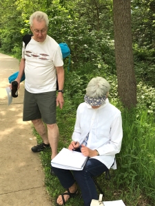 Artists sketching en plein air along Iowa City path