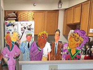 Painted foamcore figures representing teachers to attend a high school reunion