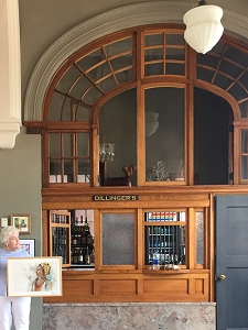 Jo Myers-Walker in front of archway with renovated woodwork at La Poste in Perry, Iowa