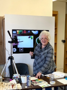 Jo Myers-Walker leading a watercolor workshop with video camera displaying what she paints