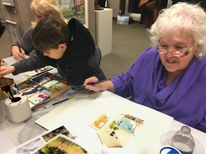 Jo Myers-Walker demonstrate watercolor painting at the opening of a show at Bereskin Gallery & Art Academy with help from friend Jeanette and a young art student
