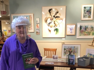 Artist Jo Myers-Walker in front of a display of her paintings inside Iowa Artisans Gallery, November 2020
