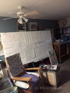 A large easel holds pencil sketch by artist Jo Myers-Walker used as a guide for wall hanging celebrating 75th anniversary of St. Thomas Aquinas church in Ames