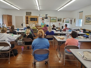 Educators listen to artist Jo Myers-Walker before working on their own creative projects