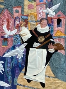 Detail of section of fabric improvisational wall hanging by artist Jo Myers-Walker depicting St. Thomas Aquinas