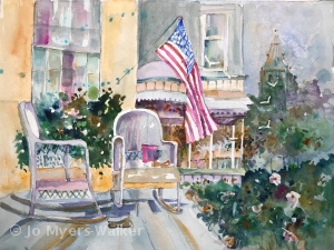 Watercolor painting by artist Jo Myers-Walker of the front porch of a house with two rocking chairs. The US flag is flying from a flagpole attached to the house.